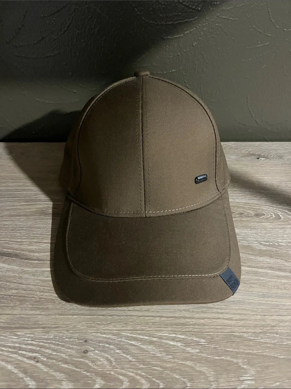 Brown Baseball Cap With Small Logo on Brim That Says “Sport Fashion”
